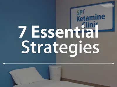 A minimalist clinic room with a single bed, a white bin, and a sign that reads 